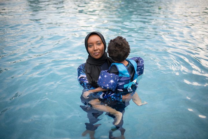 Fousia Abdullahi swims with her son at her home in Texas.