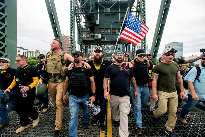 Members of the Proud Boys and other right-wing demonstrators march across the Hawthorne Bridge during an "End Domestic Terrorism" rally in Portland, Ore., on Saturday, Aug. 17, 2019.