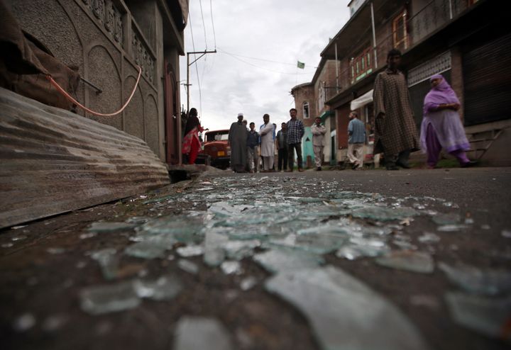 Kashmiris walk past broken window glass after clashes between protesters and the security forces on Friday evening, during restrictions, in Srinagar August 17, 2019.