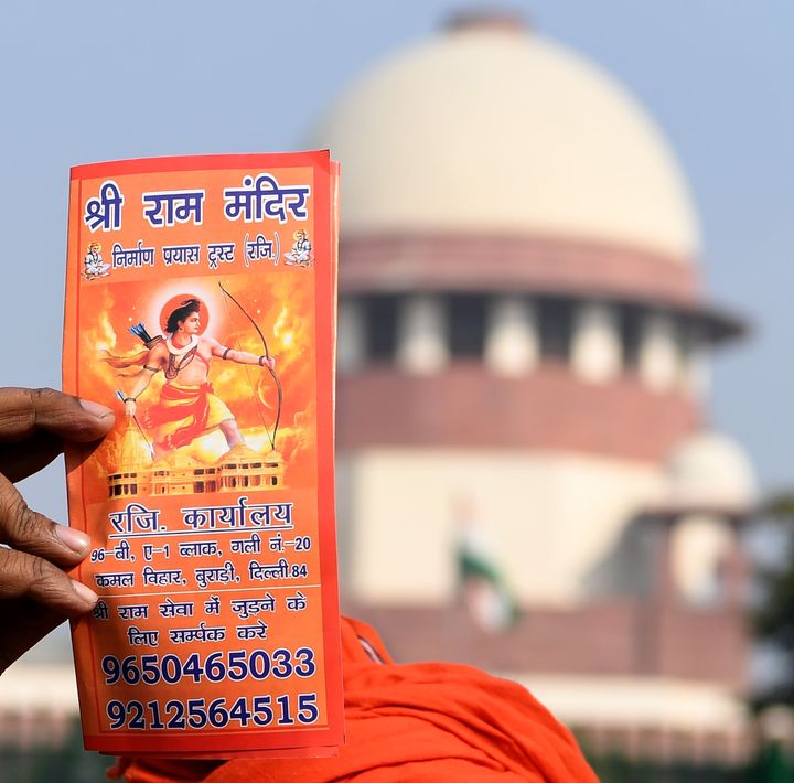 A protester holds a leaflet with the picture of Lord Ram outside the Supreme Court in New Delhi on January 10, 2019.