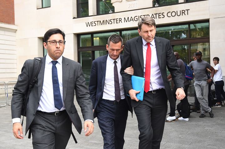 Lord Holmes of Richmond (centre) leaving Westminster Magistrates' Court, London where he appeared on charges of sexual assault