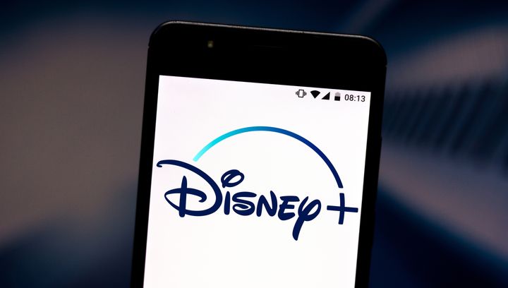 A Disney+ logo is pictured on a smartphone.