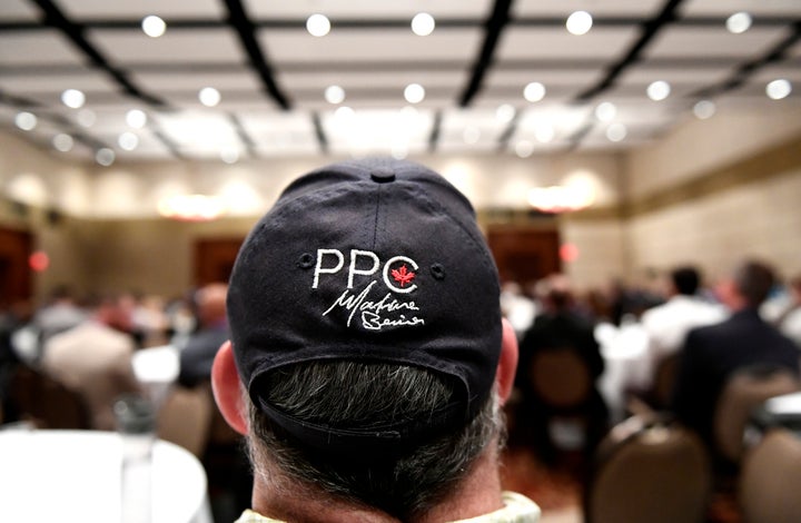 A ball cap with the logo of the People's Party of Canada and signature of leader Maxime Bernier is seen on an attendee during the PPC national conference in Gatineau, Que. on Aug. 18, 2019.