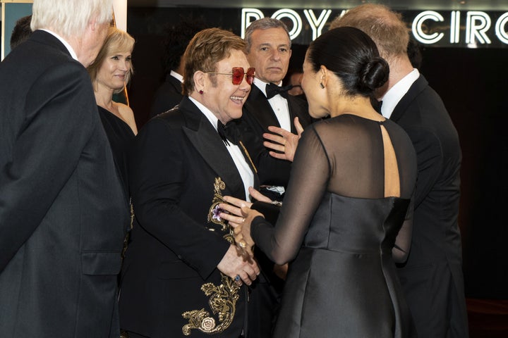 The Duke and Duchess of Sussex chat with Elton John as they arrive for the European premiere of "The Lion King" in London on July 14.