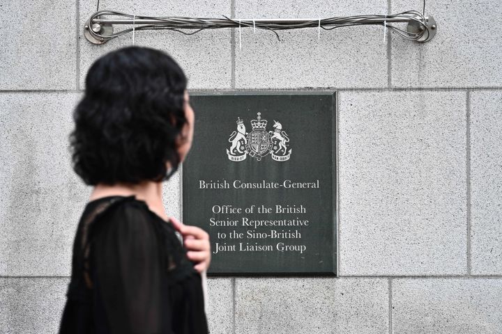 A pedestrian walks past a plaque outside the British Consulate-General building in Hong Kong (file picture)