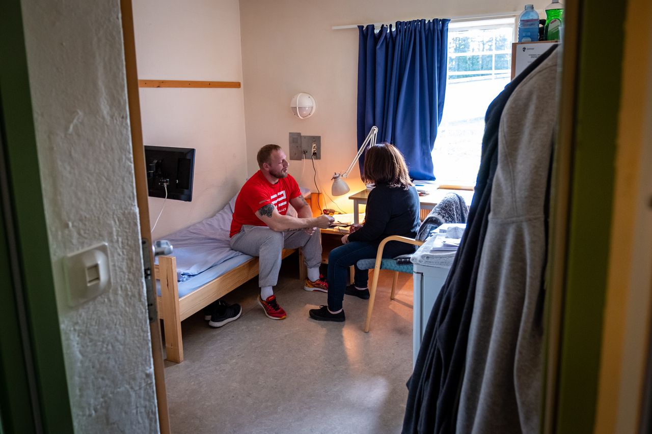 Donna Virgilio Mattia talks to Trond, a Ringerike inmate, in his cell.