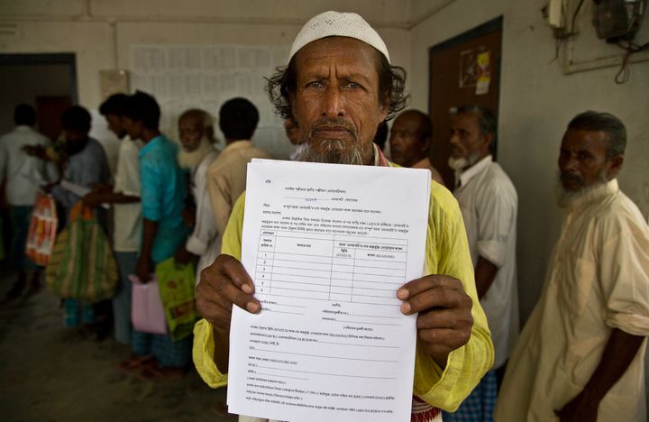 Kismat Ali, whose wife's name did not appear on the NRC draft, shows a form he collected to file an appeal in Mayong, Assam on August 10, 2018.