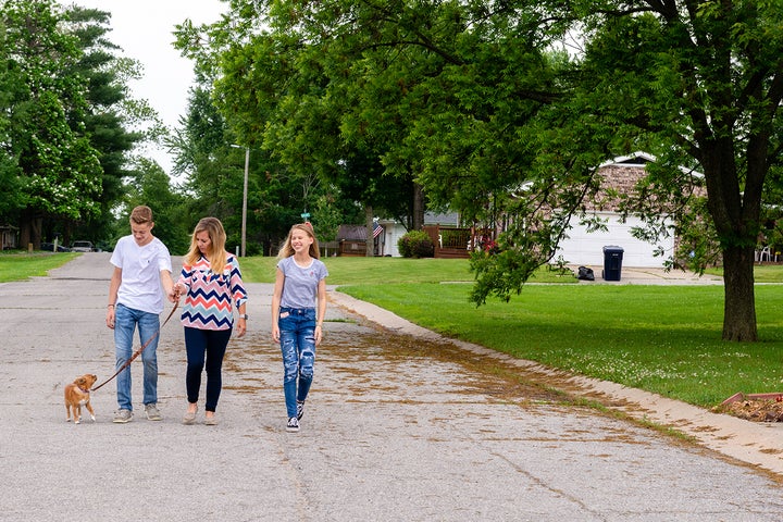 Tara Brewer, head of the Sweet Springs Chamber of Commerce, with her children, Keegan and Kendall, and dog, Sawyer. Brewer worries Sweet Springs won’t survive the closure of I-70 Community Hospital. “What is it that we’re going to have for our kids?” she asks. 