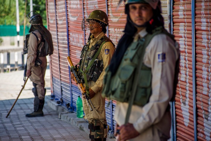 Security forces stand guard in a deserted area in Kashmir's Srinagar on August 20.