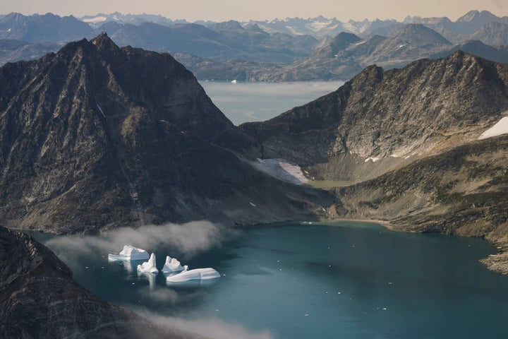 In this photo taken on Wednesday, Aug. 14, 2019, icebergs are photographed from the window of an airplane carrying NASA Scien