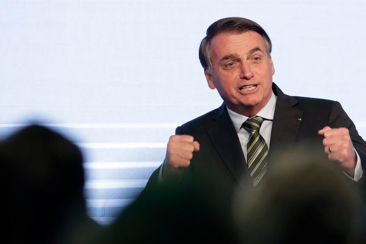 Brazil's President Jair Bolsonaro gestures after his speech to the participants of the Brazilian Steel Congress, in Brasilia, Brazil, Wednesday, Aug. 21, 2019. (AP Photo/Eraldo Peres)