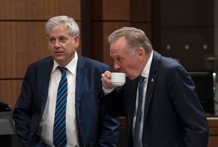 NDP MP Charlie Angus and Conservative MP Peter Kent wait for the House of Commons on Access to Information, Privacy and Ethics committee to begin on Parliament Hill in Ottawa on Aug. 21, 2019.