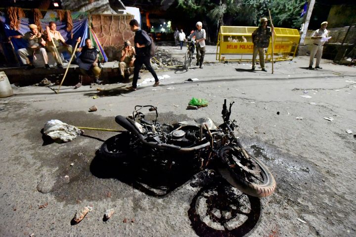 A view of the motorcycle of a Delhi police personnel that was burnt by people during the protest.