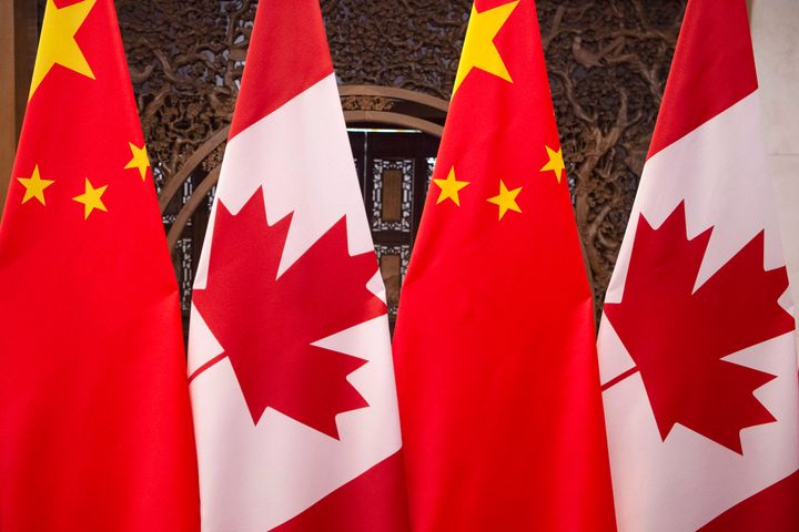This Dec. 5, 2017, photo shows flags of Canada and China prior to a meeting between the leaders of the two countries in Beijing.