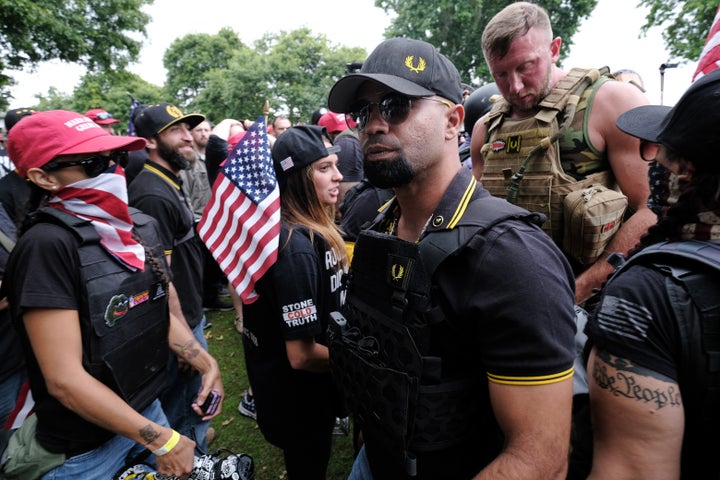 Proud Boys head Enrique Tarrio (center, wearing sunglasses at a rally last weekend in Portland, Oregon.