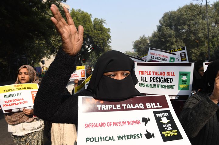 Activists of Women India Movement (WIM) shout slogans as they hold placards against the 'Triple Talaq Bill' during a protest in New Delhi on January 4, 2018.