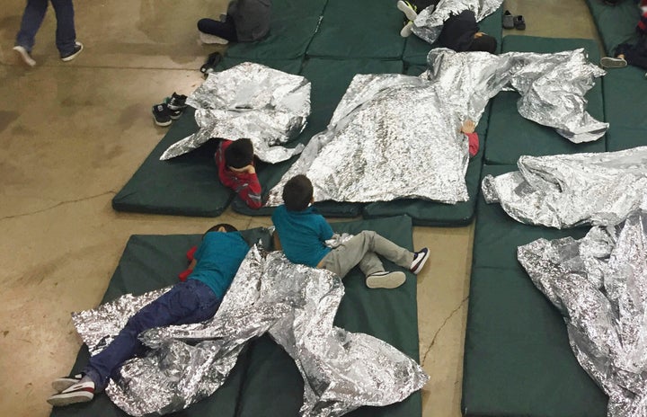 In this Sunday, June 17, 2018, file photo provided by U.S. Customs and Border Protection, people who've been taken into custody related to cases of illegal entry into the United States rest in one of the cages at a facility in McAllen, Texas. 