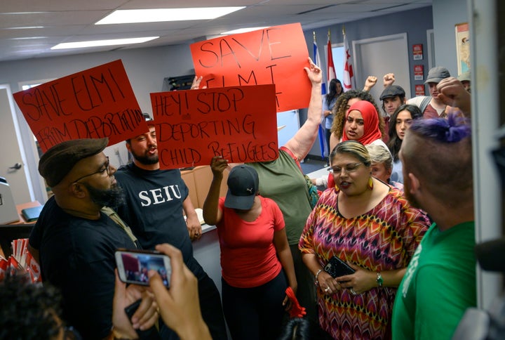 Demonstrators chant in MP Andy Fillmore's constituency office advocating for a stay on the deportation of Abdilahi Elmi to Somalia during a protest in Halifax on Tuesday.