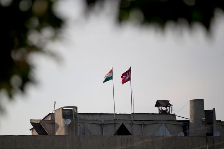 In this Friday, Aug. 9, 2019, photo, an Indian national flag, left, flies next to a Jammu and Kashmir state flag on the Civil Secretariat building in Srinagar, Indian controlled Kashmir. Authorities enforcing a strict curfew in Indian-administered Kashmir will bring in trucks of essential supplies for an Islamic festival next week, as the divided Himalayan region remained in a lockdown following India's decision to strip it of its constitutional autonomy. The indefinite 24-hour curfew was briefly eased on Friday for weekly Muslim prayers in some parts of Srinagar, the region's main city, but thousands of residents are still forced to stay indoors with shops and most health clinics closed. All communications and the internet remain cut off.