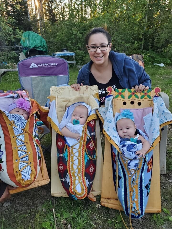 Michelle Kakegamic has been carrying her three daughters Hiliary Rose, Heather Grace, and Haddison Joy in tikinagans since they were discharged from the hospital.