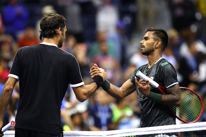 Roger Federer shakes hands with Sumit Nagal after their Men's Singles first-round match on day one of the US Open.
