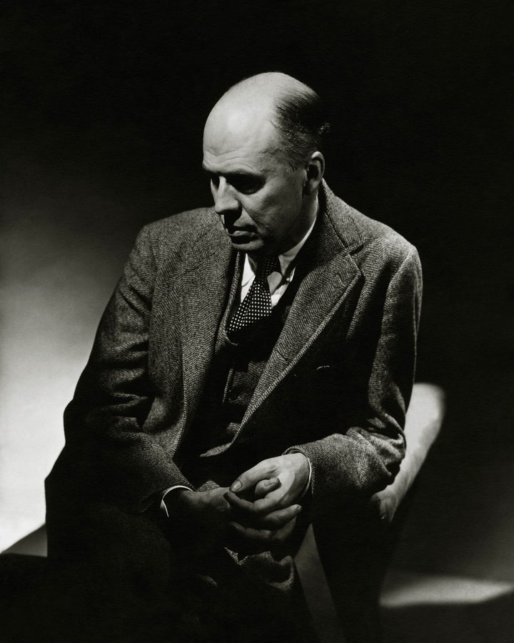 Artist, Edward Hopper, wearing a three-piece tweed suit, and polka dot tie, sitting in an arm chair in partial shadow, and looking down with a somber expression. (Photo by Lusha Nelson/Condé Nast via Getty Images)