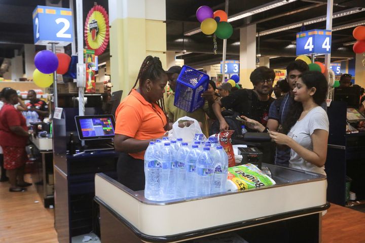 People buy bottled water in preparation for the arrival of Tropical Storm Dorian at a supermarket in Gros Islet, St. Lucia August 26, 2019. REUTERS/Andrea de Silva
