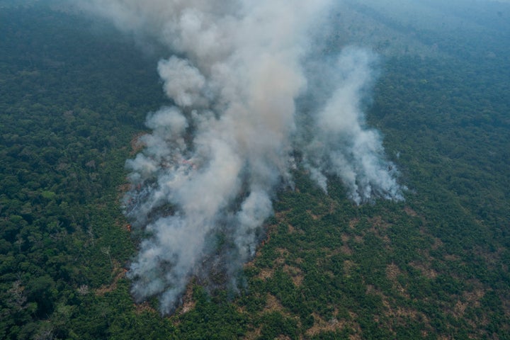 Fire consumes an area near Porto Velho, Brazil, on Friday. Brazilian state experts have reported a record of nearly 77,000 wi