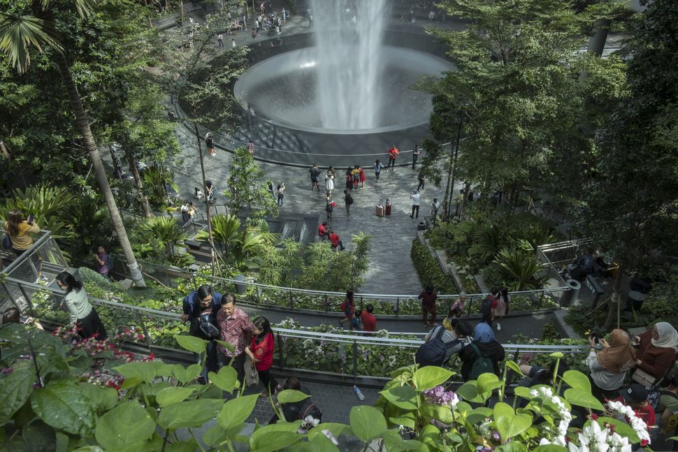 SINGAPORE - JULY 21: Visitors tour around the HSBC Rain Vortex, the worlds tallest indoor waterfall, at Jewel Changi Airport in Changi, Singapore on July 21, 2019. (Photo by Adli Ghazali/Anadolu Agency via Getty Images)