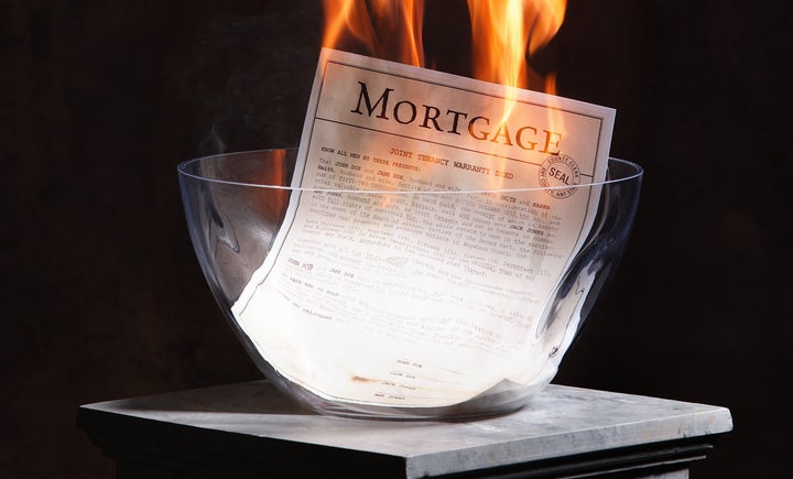 A home mortgage being burnt after the home is paid off