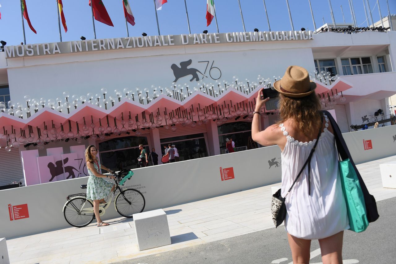 A festival goer has her picture taken in front of the Sala Grande cinema at the 76th edition of the Venice Film Festival in Venice, Italy, Tuesday, Aug. 27, 2019. The film festival runs from Aug. 28 until Sep. 7, 2019 and international movie stars Brad Pitt, Meryl Streep and many others will be in attendance. (Photo by Arthur Mola/Invision/AP)