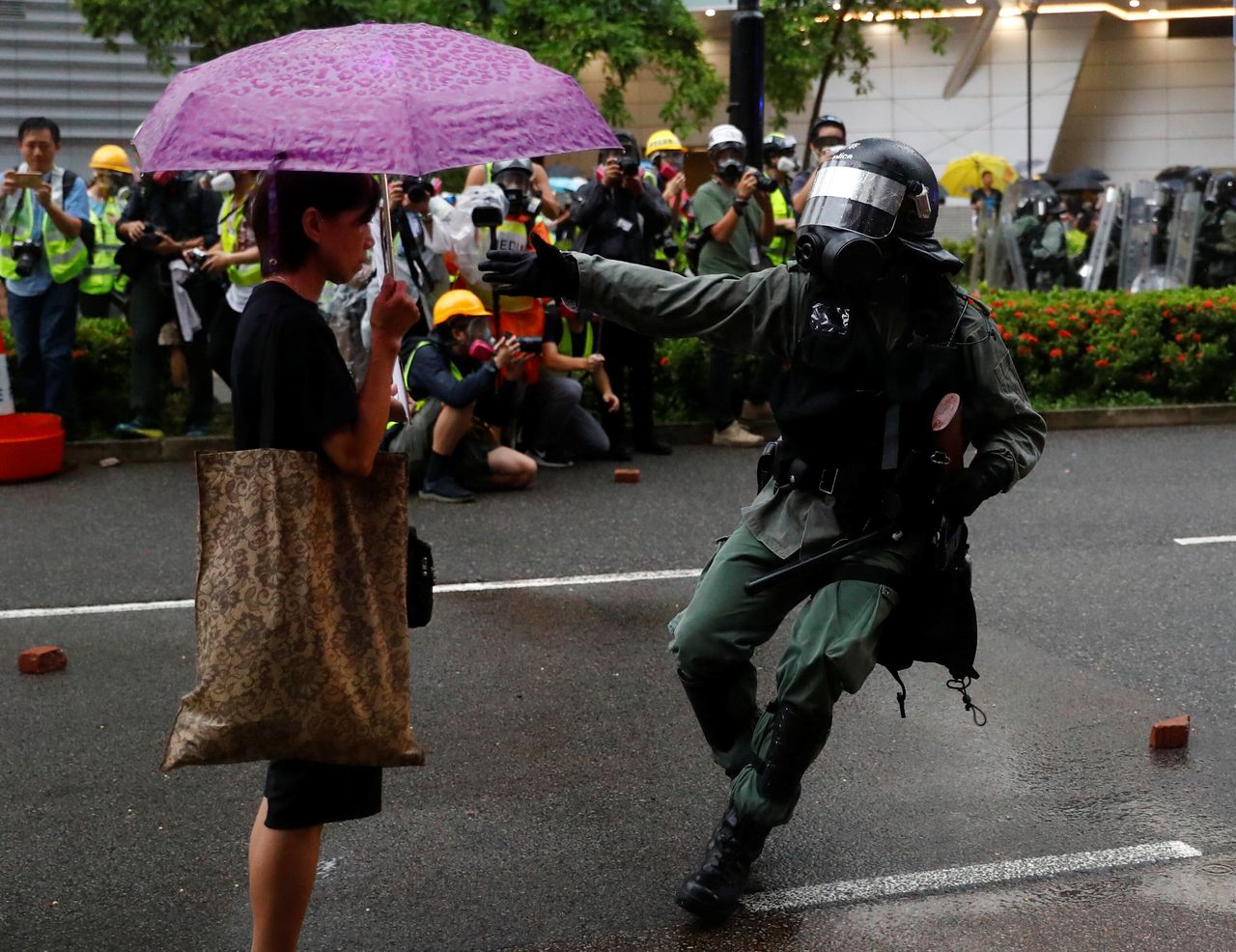Riot police officer approaches a demonstrator during a protest in Tsuen Wan, in Hong Kong, August 25, 2019.