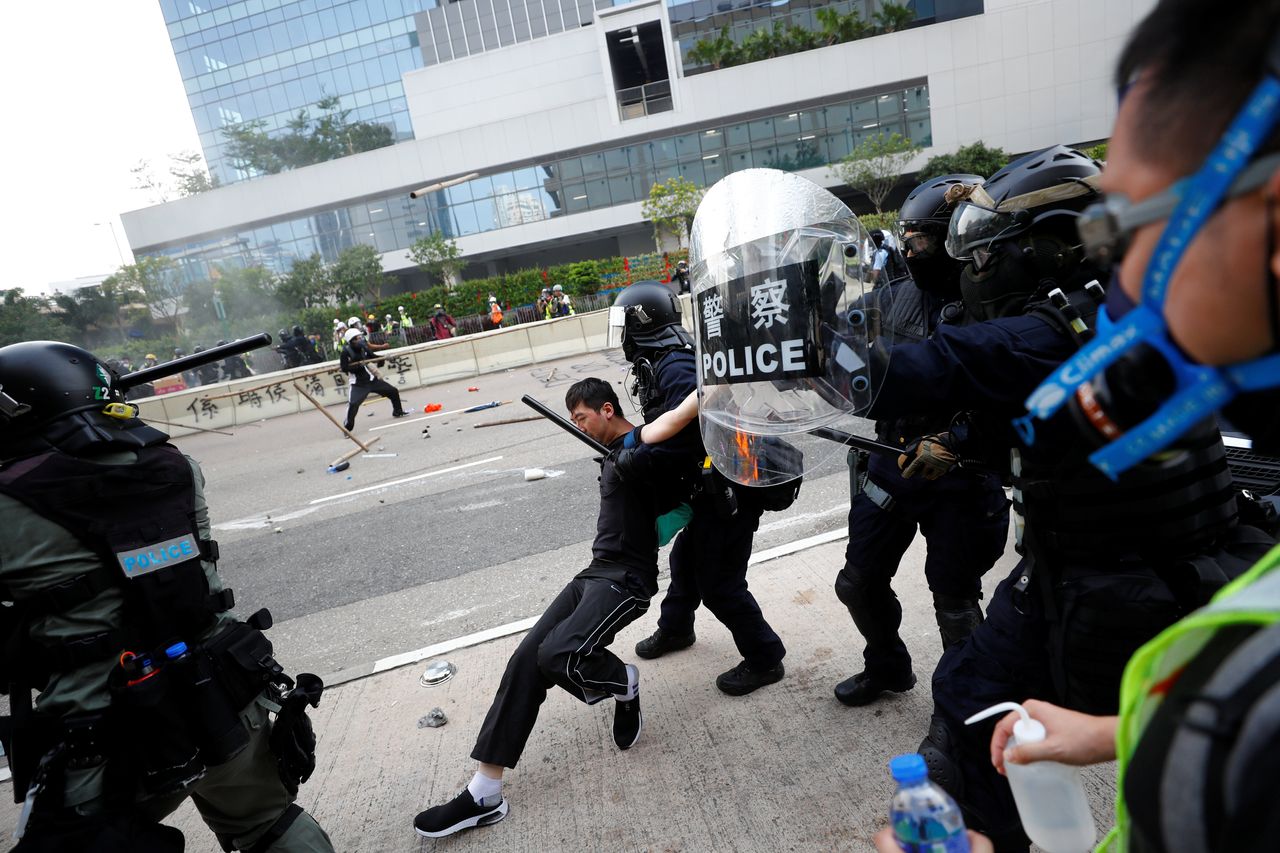 Riot police detain a demonstrator as they clash during a protest in Hong Kong, August 24, 2019. 