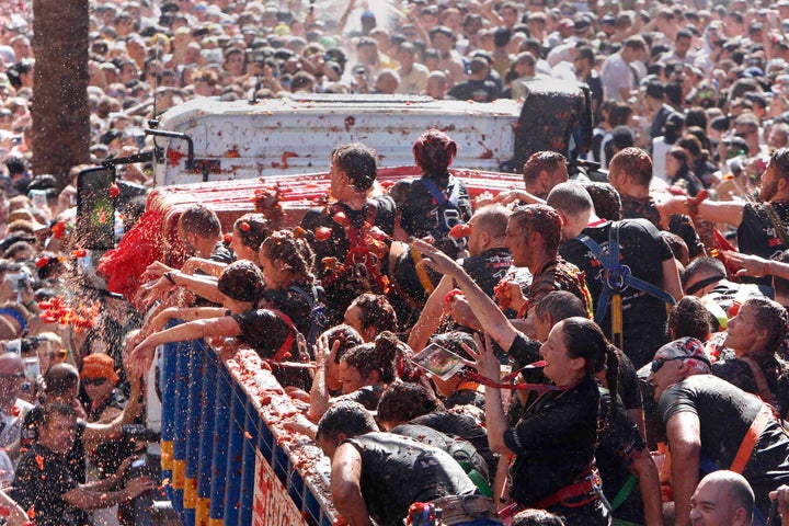 Revellers throw tomatoes at each other during the annual "Tomatina" tomato fight fiesta in the village of Bunol near Valencia, Spain, Wednesday, Aug. 28, 2019. (AP Photo/Alberto Saiz)