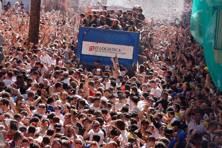 Revellers throw tomatoes at each other during the annual "Tomatina" tomato fight fiesta in the village of Bunol near Valencia, Spain, Wednesday, Aug. 28, 2019. (AP Photo/Alberto Saiz)