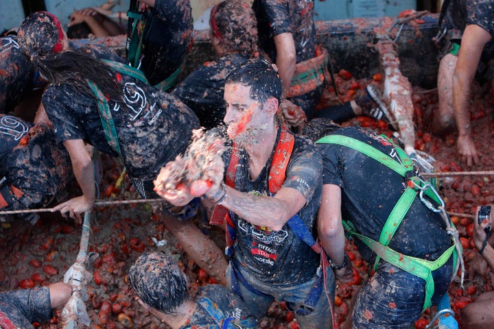 Revellers throw tomatoes at each other during the annual "Tomatina" tomato fight fiesta in the village of Bunol near Valencia, Spain, Wednesday, Aug. 28, 2019. (AP Photo/Alberto Saiz)