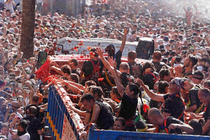 Revellers throw tomatoes at each other during the annual "Tomatina" tomato fight fiesta in the village of Bunol near Valencia, Spain, Wednesday, Aug. 28, 2019. (AP Photo/Alberto Saiz)