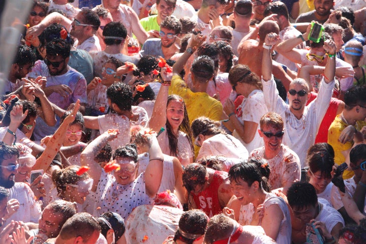 Revellers throw tomatoes at each other, during the annual "Tomatina" tomato fight fiesta in the village of Bunol near Valencia, Spain, Wednesday, Aug. 28, 2019. (AP Photo/Alberto Saiz)