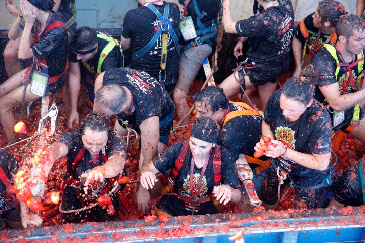 Revellers throw tomatoes at each other, during the annual "Tomatina" tomato fight fiesta in the village of Bunol near Valencia, Spain, Wednesday, Aug. 28, 2019. (AP Photo/Alberto Saiz)