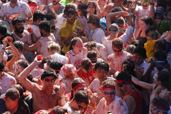 Revellers throw tomatoes at each other, during the annual "Tomatina" tomato fight fiesta, in the village of Bunol, near Valencia, Spain, Spain, Wednesday, Aug. 28, 2019. (AP Photo/Alberto Saiz)