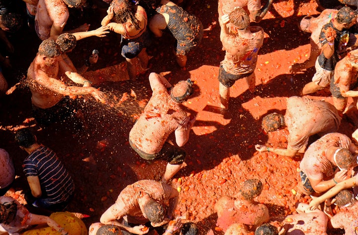 Revellers throw tomatoes during the annual "La Tomatina" food fight festival in Bunol, near Valencia, Spain, August 28, 2019. REUTERS/Heino Kalis