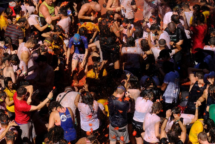 Revellers throw tomatoes during the annual "La Tomatina" food fight festival in Bunol, near Valencia, Spain, August 28, 2019. REUTERS/Heino Kalis