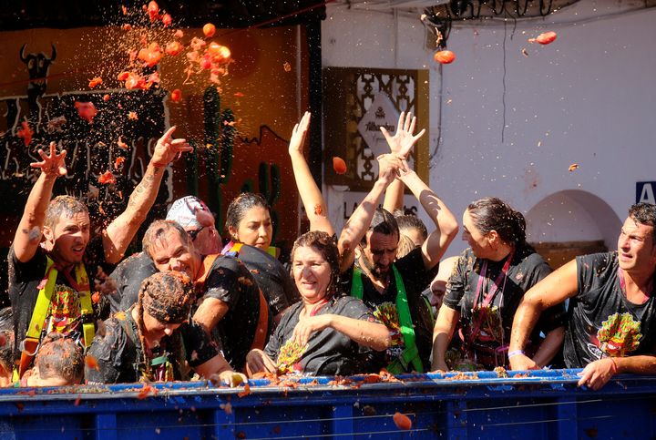Revellers on a truck throw tomatoes into the crowd during the annual "La Tomatina" food fight festival in Bunol, near Valencia, Spain, August 28, 2019. REUTERS/Heino Kalis