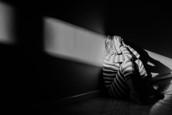 A young girl in stripey pyjamas having some time out.