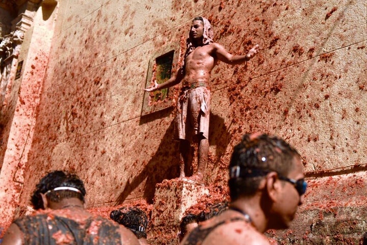 VALENCIA, SPAIN - AUGUST 28: A man with his arms opened is seen participating in the festival of ‘La Tomatina’ in Buñol on August 28, 2019, in Valencia, Spain. (Photo by Jorge Gil/Europa Press via Getty Images) 