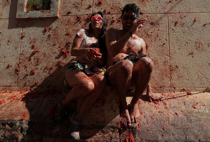 Revellers react during the annual "La Tomatina" food fight festival in Bunol, near Valencia, Spain, August 28, 2019. REUTERS/Juan Medina