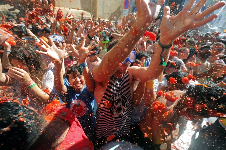 Revellers throw tomatoes during the annual "La Tomatina" food fight festival in Bunol, near Valencia, Spain, August 28, 2019. REUTERS/Juan Medina