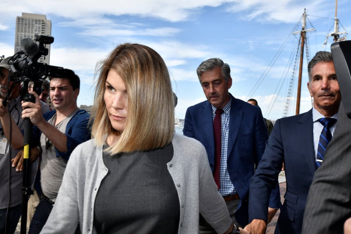 Actress Lori Loughlin, and her husband, fashion designer Mossimo Giannulli leave the federal courthouse after a hearing on ch