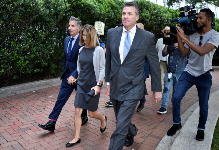 Actress Lori Loughlin and her husband, fashion designer Mossimo Giannulli, arrive at the federal courthouse for a hearing on