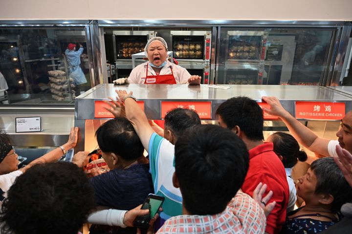 Shoppers jostle for roast chicken in China's first Costco 